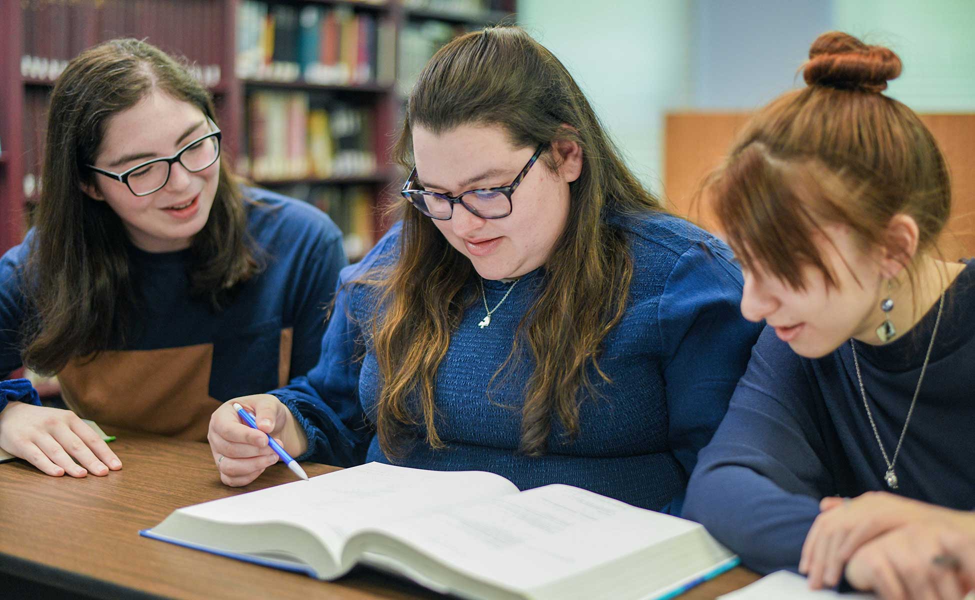 HTC students reading together in library