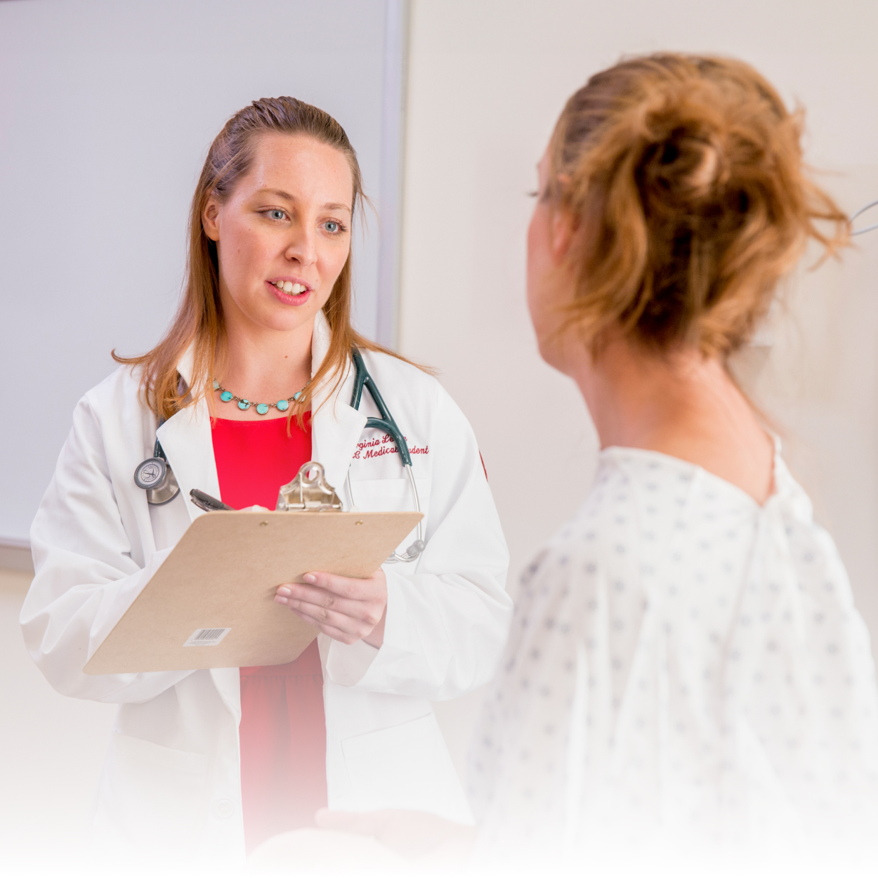 Female doctor speaking with patient in clinic