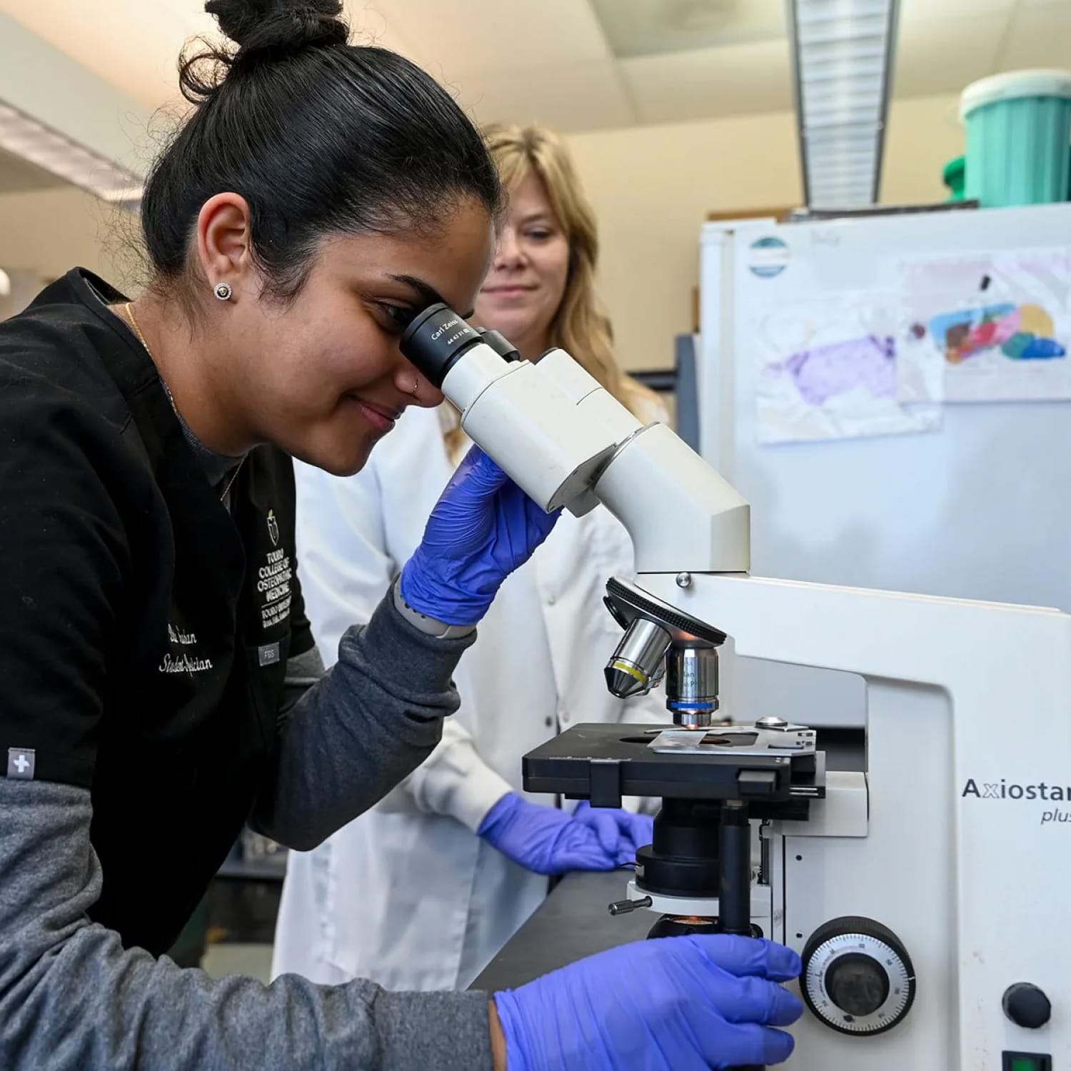 researcher looking into a microscope