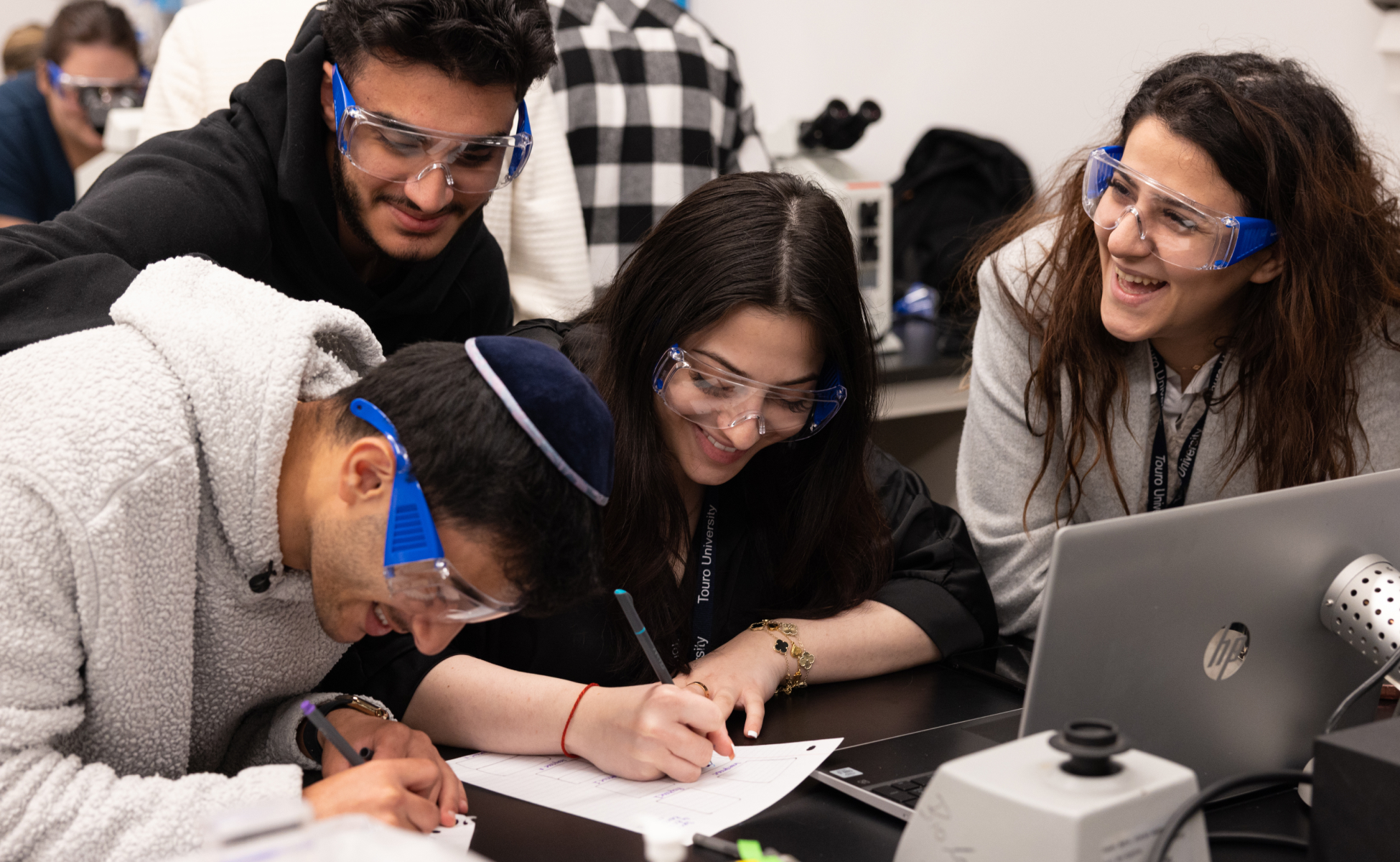 Diverse group of students working in science lab