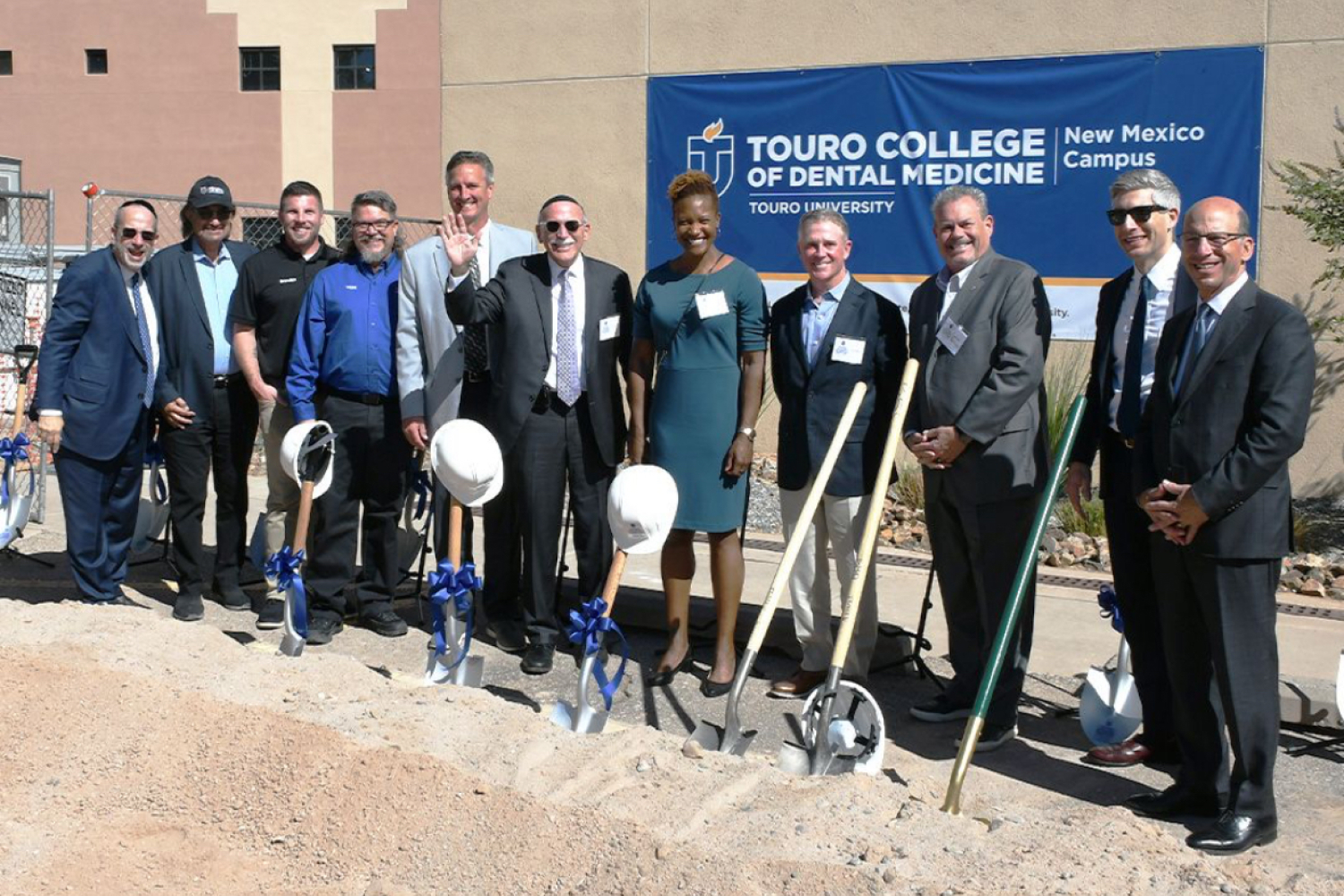 Administrative and faculty members standing with shovels at breaking ground ceremony at Albuquerque campus.